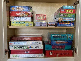 Adult and children's games stored in the island cabinet.