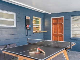 Ping pong table that can convert to outdoor dining. Pass through serving bar with access to the kitchen.