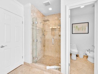 Large shower with toilet and bidet in a separate room for privacy