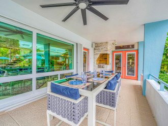 Private dining patio fit for six with pool and canal views.