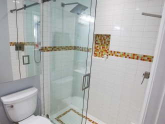 Couples walk in shower with rain shower and adjustable hand held.