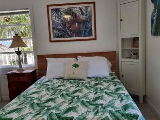 The palm room (queen size bed) features views of the ocean and the canal