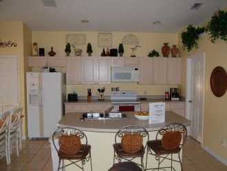 Kitchen and breakfast bar, table to your left and laundry room to the right.
