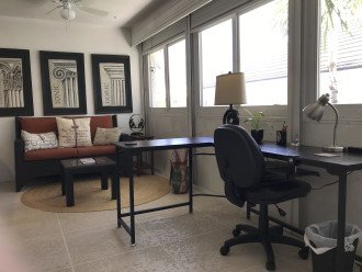 L-shaped desk with office chair and plenty of natural light