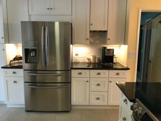 Modern appliances in newly renovated kitchen include coffee maker, fridge/freezr