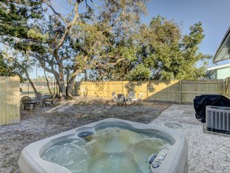 Back yard with hot tub, grill and seating