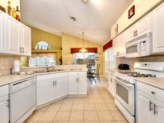 Fully equipped kitchen with doors leading to the pool area