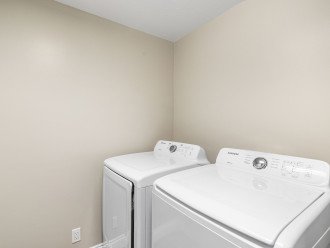 Private laundry room with washer and dryer