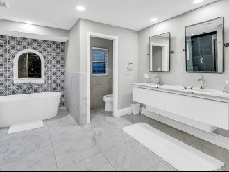 Master bathroom vanity, toilet room and tub.
