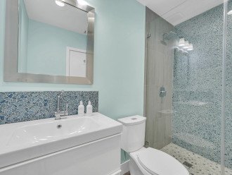The guest bathroom has a full shower.