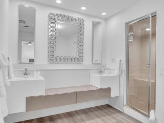 The luxurious master bathroom features a double vanity and shower.