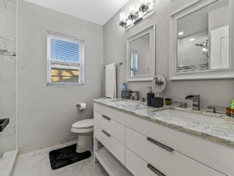 Full guest bathroom with dual sinks
