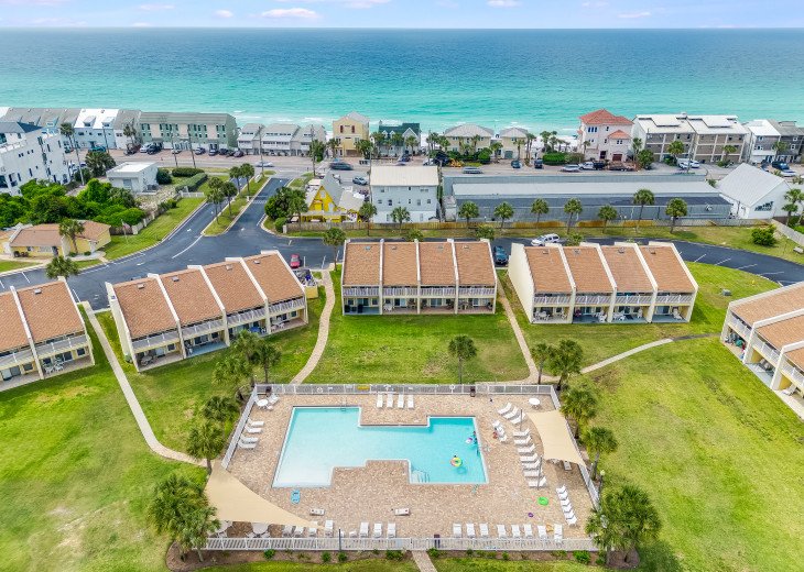 Aerial of condo and pool with nearby beach
