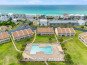 Aerial of condo and pool with nearby beach