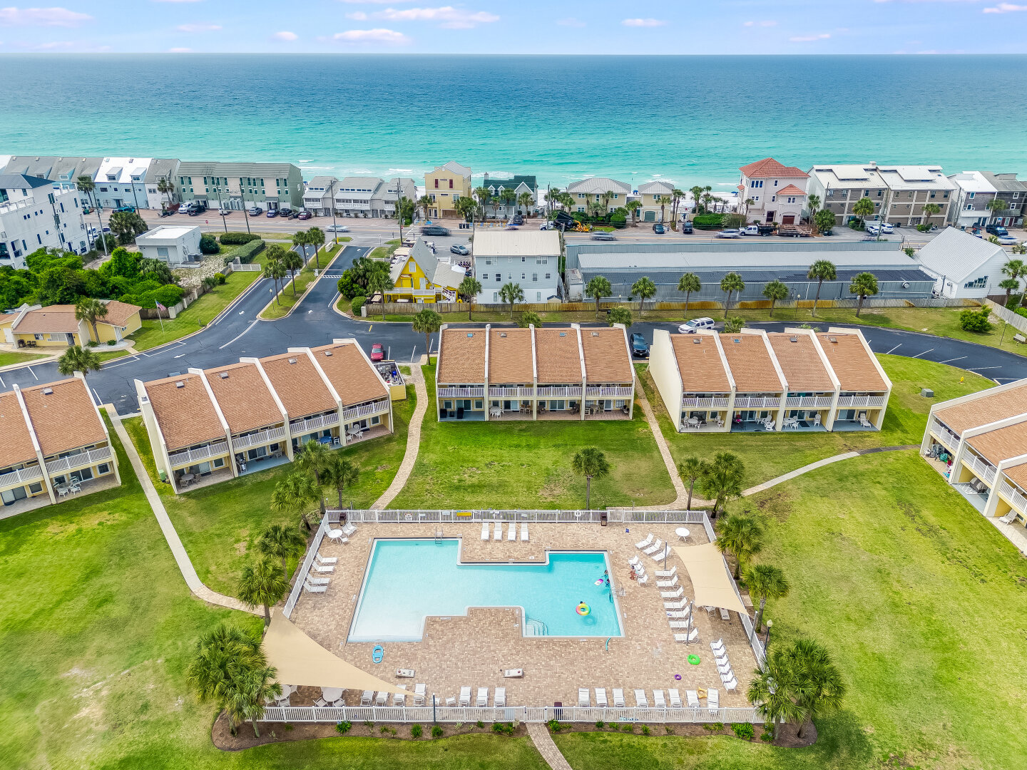 Aerial of condo and pool with nearby beach