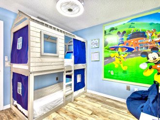 The 5th bedroom has bunk beds and a Disney theme