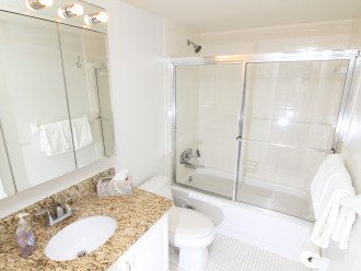 Take a tub bath or shower off your sand in the updated guest bathroom.