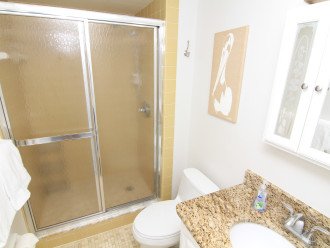The Master Bathroom includes granite counter-tops, a tile and glass shower, and plush white spa towels.