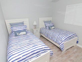 The extra bedroom has 2 twin beds and all new flooring.