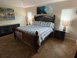 Expansive King Bed Owners Suite with Wall Mounted TV
