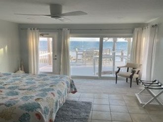 Large master bedroom with beautiful deck! Table and chairs on top deck