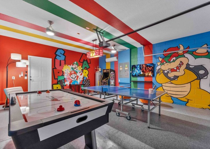 Super Mario Bros. game room with arcade, air hockey, and ping pong.