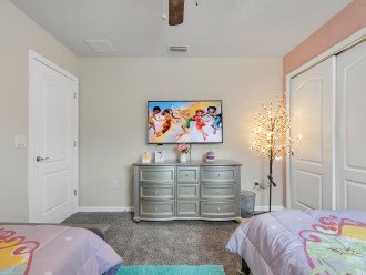 Princess room with 2 twin sized beds and TV