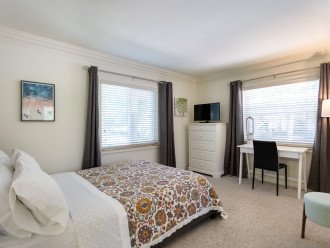 Master Bedroom with queen bed, tv and writing desk