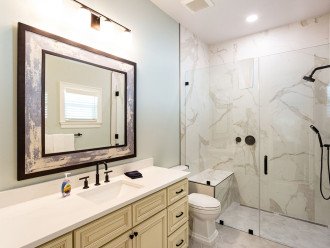 En-suite bathroom #3 with huge single vanity and walk-in shower with bench.