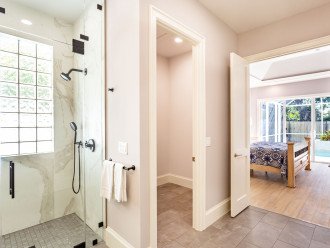 Master bathroom with double vanity, zero threshold walk-in shower and walk-in closet.