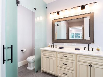 Master bathroom with private toilet area, double vanity, walk-in shower and walk-in closet.