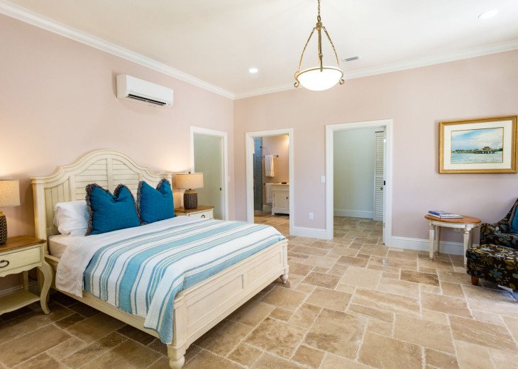 Master bedroom with queen bed, two walk-in closets, full bathroom, writing desk and direct access to the pool