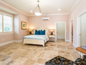 Master bedroom with queen bed, two walk-in closets, full bathroom, writing desk and direct access to the pool