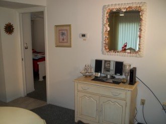 Dining area door to guest bedroom & credenza and shell mirror