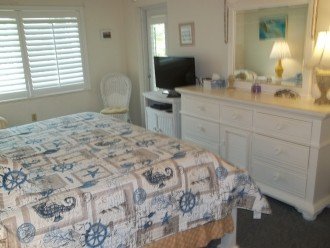 Master bedroom with 32 inch HDTV and door to the balcony (lanai).