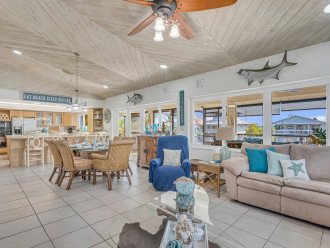 Screened porch with sofas, table, TV for great Morning Coffee and Breakfast