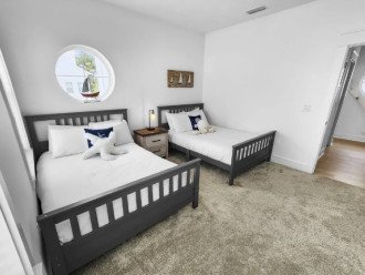 third bedroom features two-full beds with a fun port window
