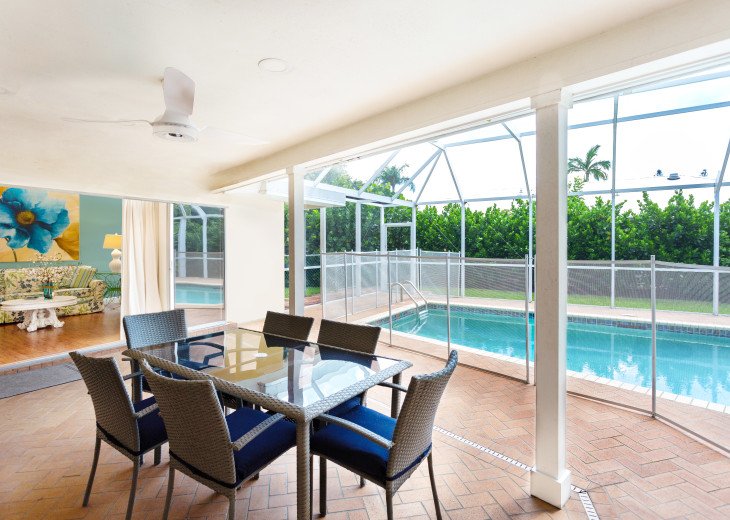 Outdoor sitting and dining area. Home comes with removable child's safety fence around the pool