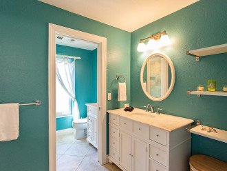 Master bathroom with open single vanity and walk-in shower + single vanity