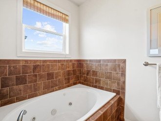 The Sunlounger beach front king suite bathroom whirlpool bathtub