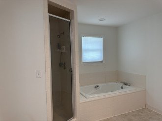 High Tunes King master suite bathroom with shower and bathtub