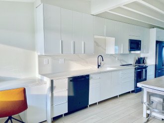 Incredible modern kitchen with full quartz single slab counters/backsplash