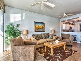 Living Room with Flat Screen TV, Fan, and Entrance to Lanai Area with Lake and Golf Views; Couch is a Pull Out!