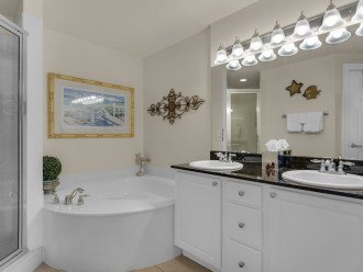 Double vanity, soaking tub, and walk in tiled shower