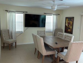Dinning area next to kitchen and pool patio door to lanai.