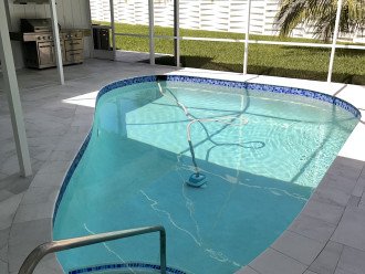 Remodeled Pool with white marble decking. Stainless BBQ grill.
