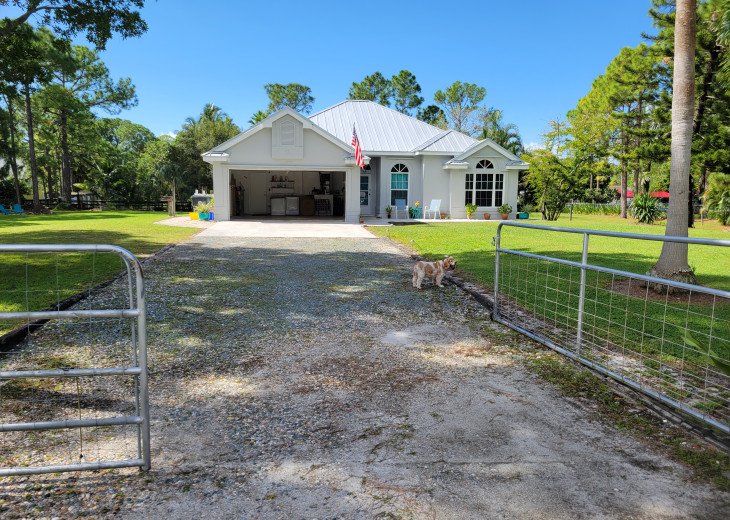 Pictured from the front gate. Two acres of property for you to enjoy.