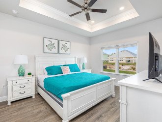luxury master suite offers a comfortable king bed, flat-screen Roku television, and ceiling fan.