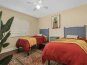 Bright guest bedroom with two full beds, providing a peaceful retreat for guests