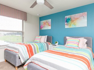 A colorful twin/twin bedroom that is perfect for the kids to rest in